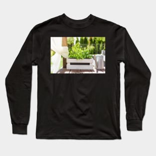 White wooden pot with green herbs on a wooden terrace Long Sleeve T-Shirt